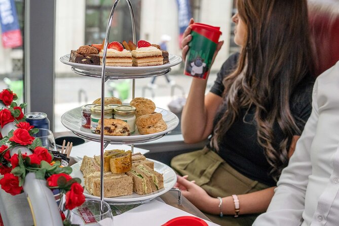 London: Afternoon Tea Bus Tour with Prosecco & London Eye Option - Afternoon tea with London moving outside the window